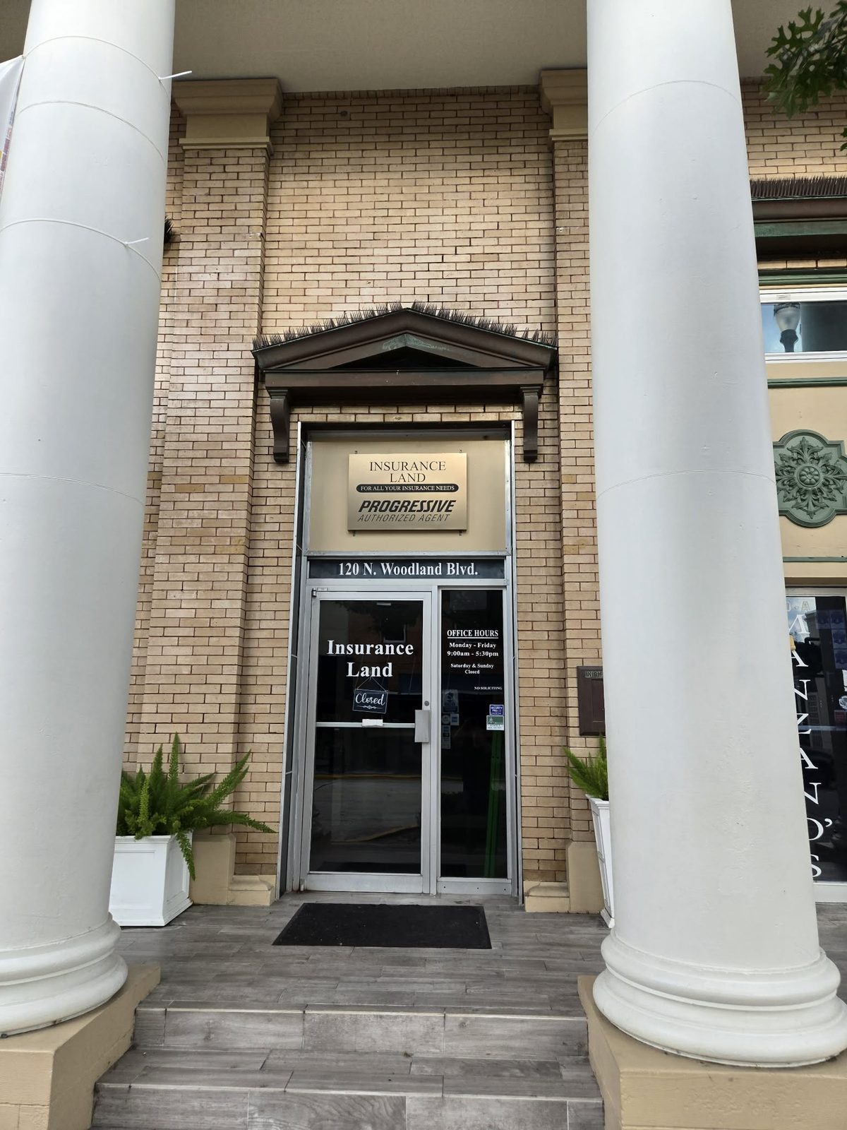 Columned entrance to the Insurance Land office at 120 N Woodland Blvd in downtown DeLand.