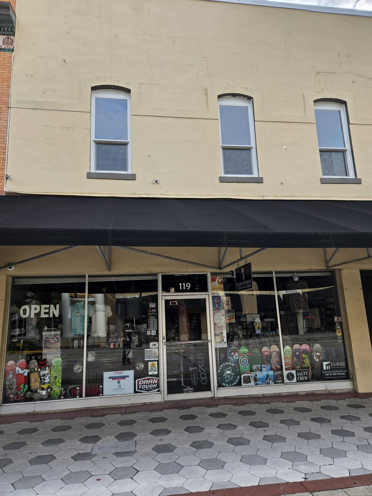 Storefront of Empires Emporium with skateboards displayed in the windows in downtown DeLand.