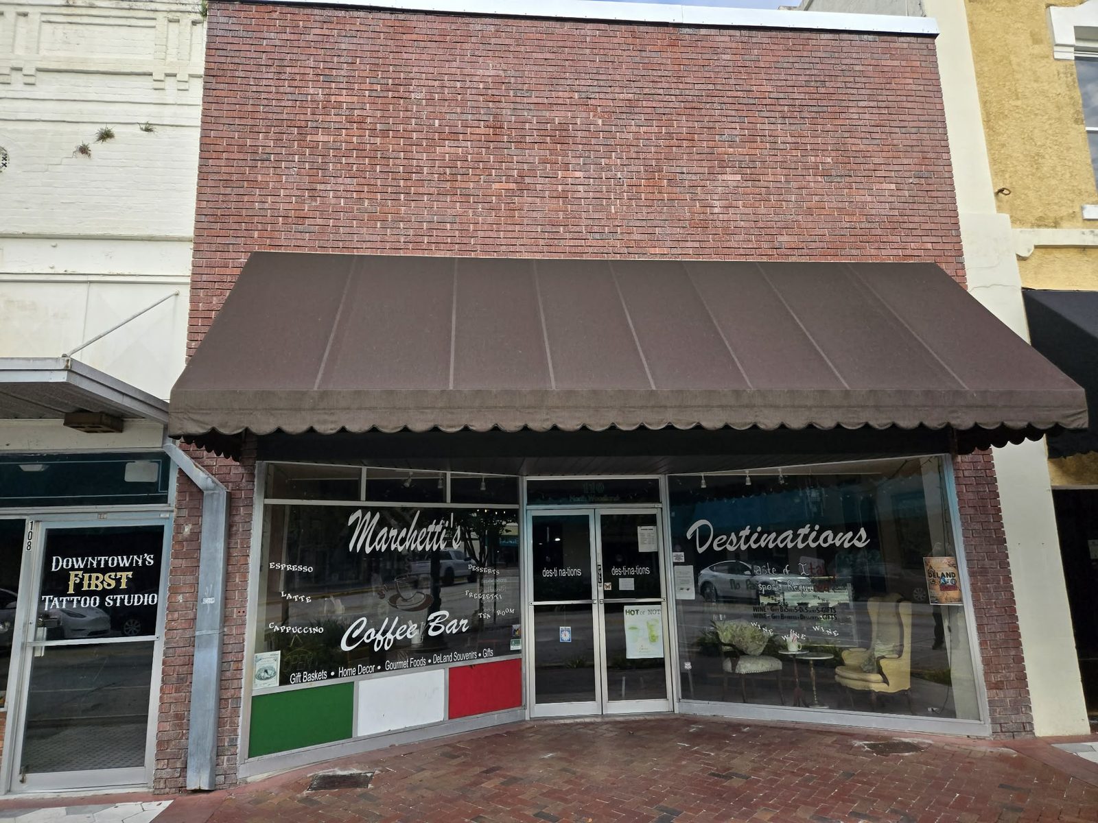 Full facade of Destinations and Marchetti's Coffee Bar in a brick building in downtown DeLand.